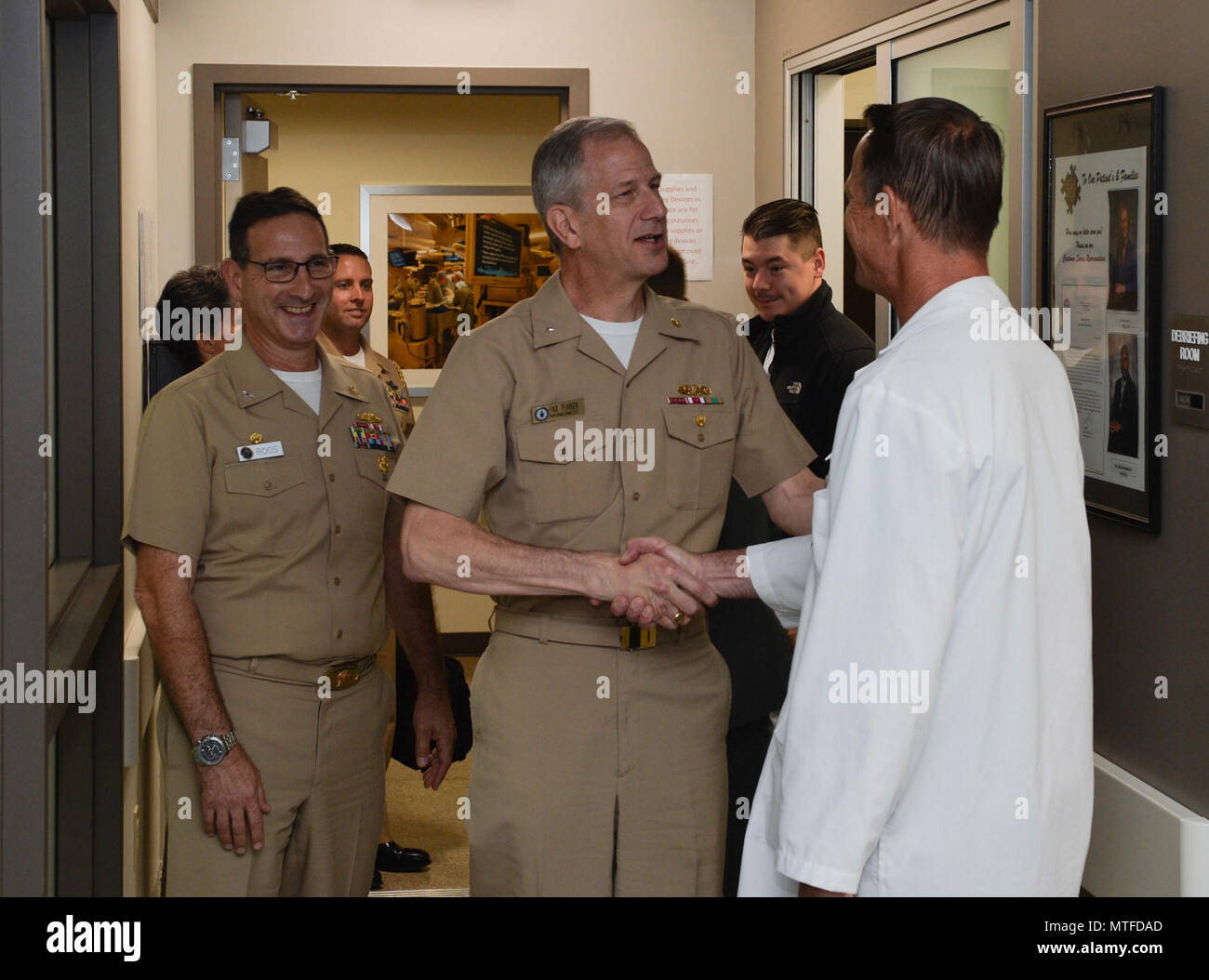 SAN DIEGO (April 24, 2017) Dr. Kerry King (right), medical director, Naval Medical Center San Diego (NMCSD) Surgical Simulation Center, greets Rear Arm. Paul Pearigen, commander, Navy Medicine West, before touring the training spaces. Pearigen toured NMCSD and visited the Medical and Surgical Sim Center, Bio Skills Training Center and Emergency Department before holding an Admiral’s call and answering Sailors’ questions. Stock Photo