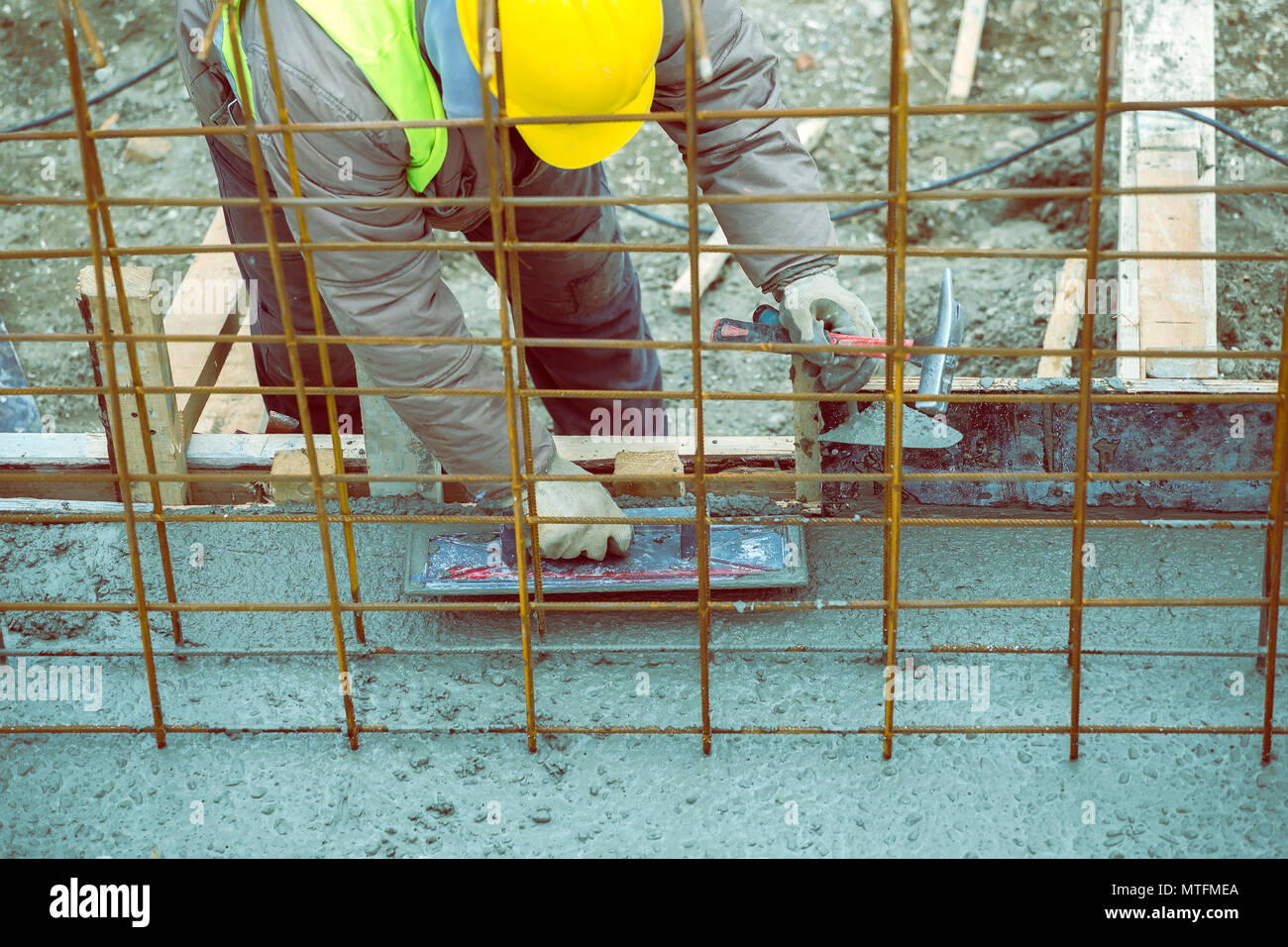 Red cement mix and trowel on the construction site Stock Photo - Alamy