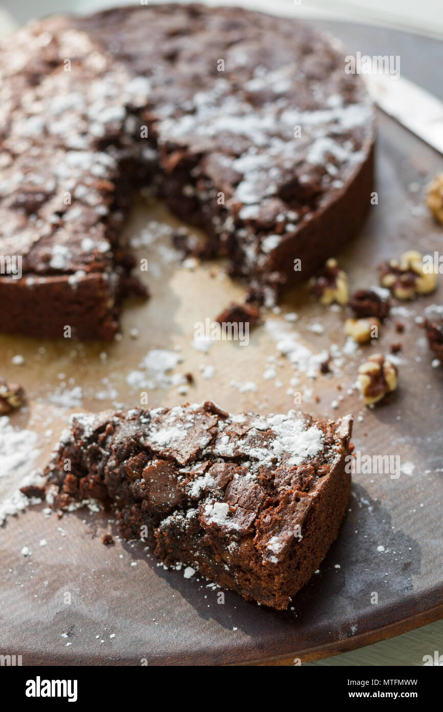 Chocolate Brownie with powdered sugar, chocolate chips, and walnuts. On
