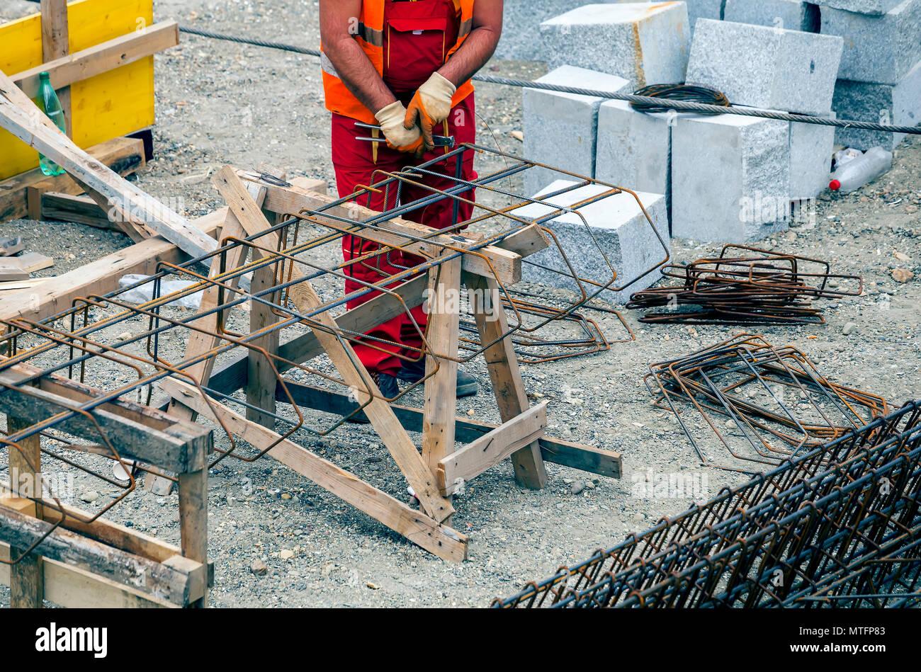 Worker hands making reinforcement metal framework for concrete pouring ...