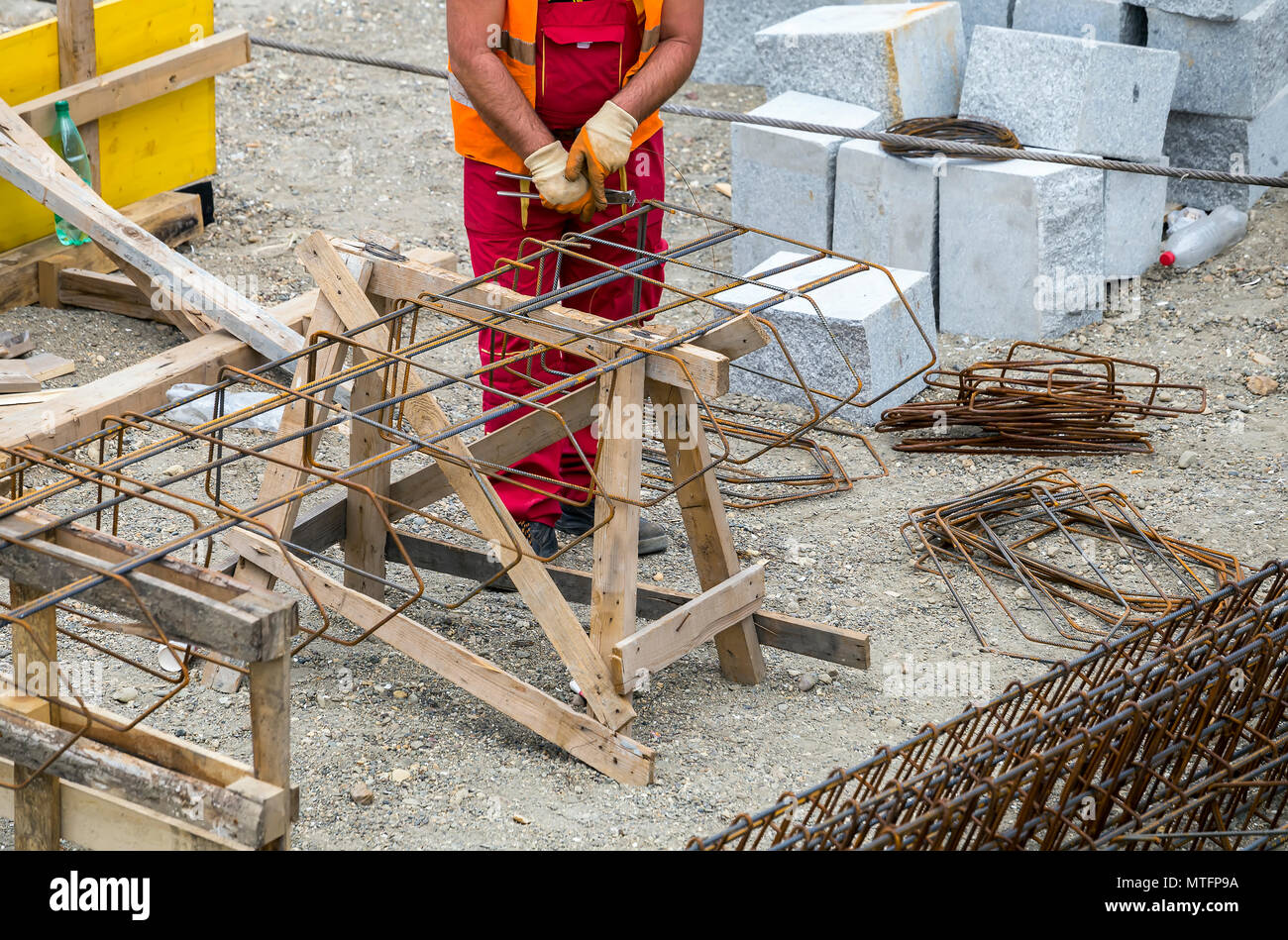 Worker making reinforcement metal framework for concrete pouring at the ...