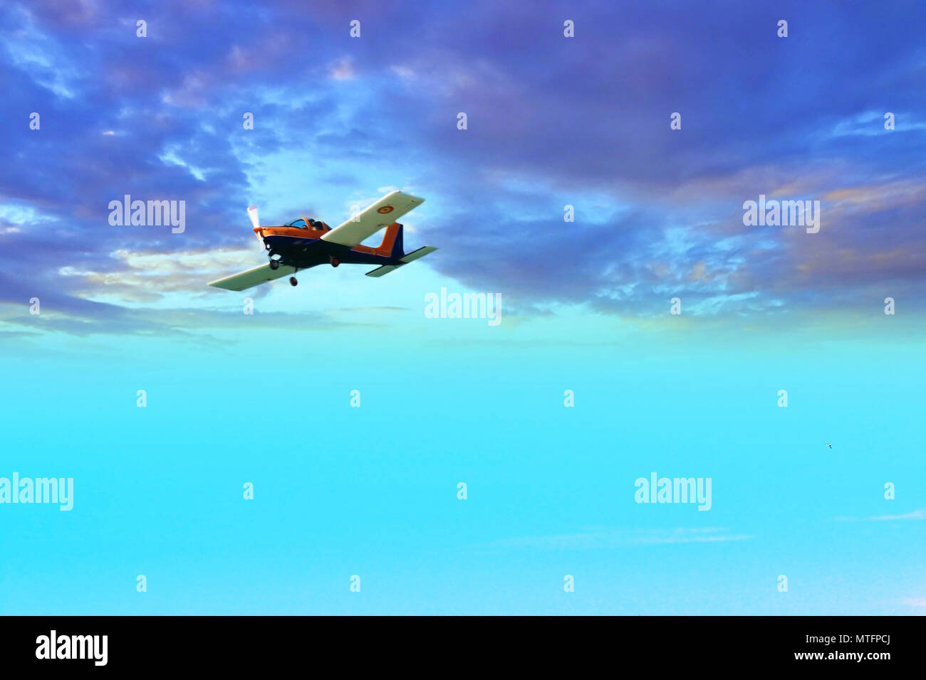 Airplane flying between stormy clouds Stock Photo