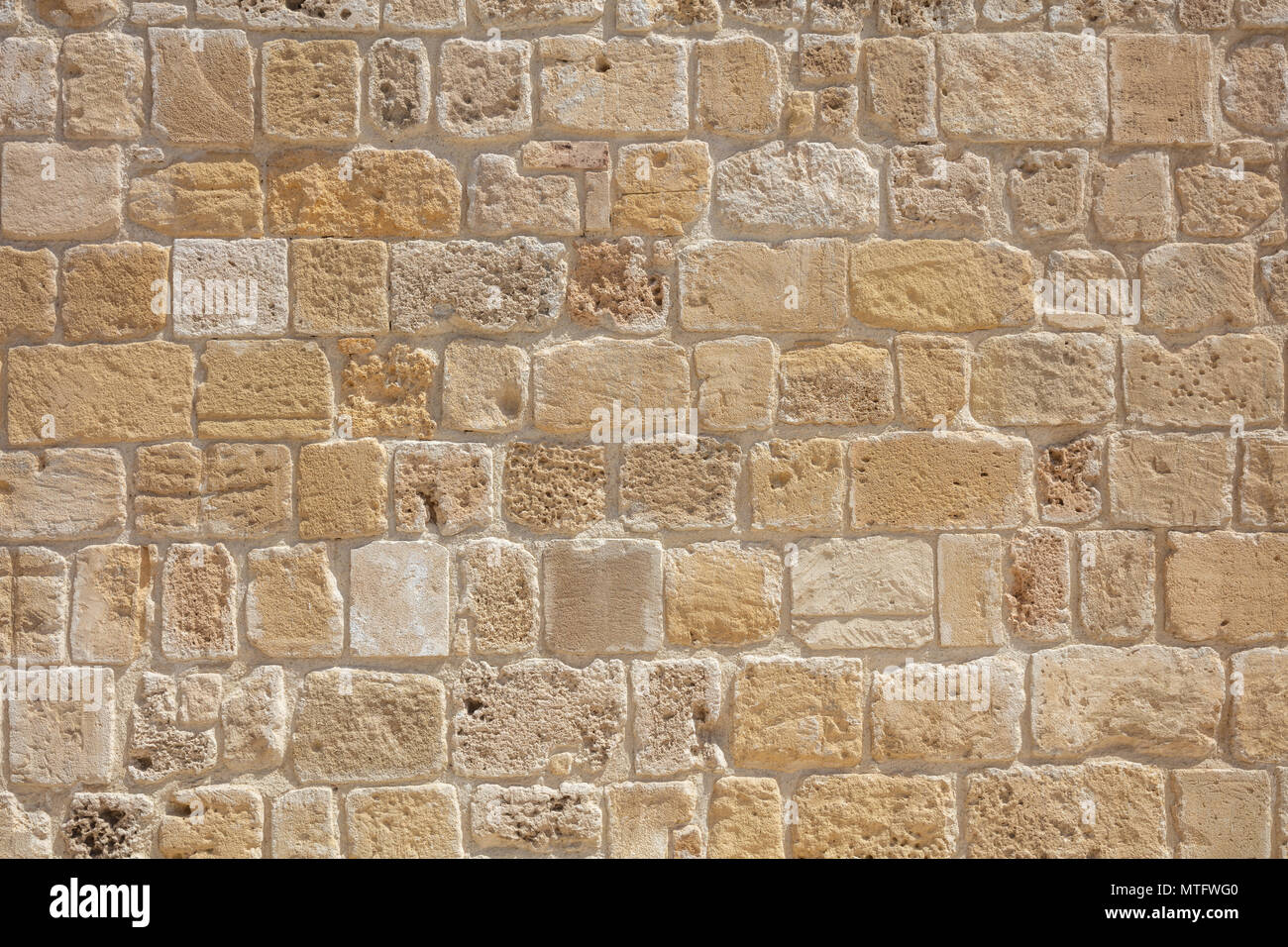 Traditional sand stone wall background in Cyprus Stock Photo