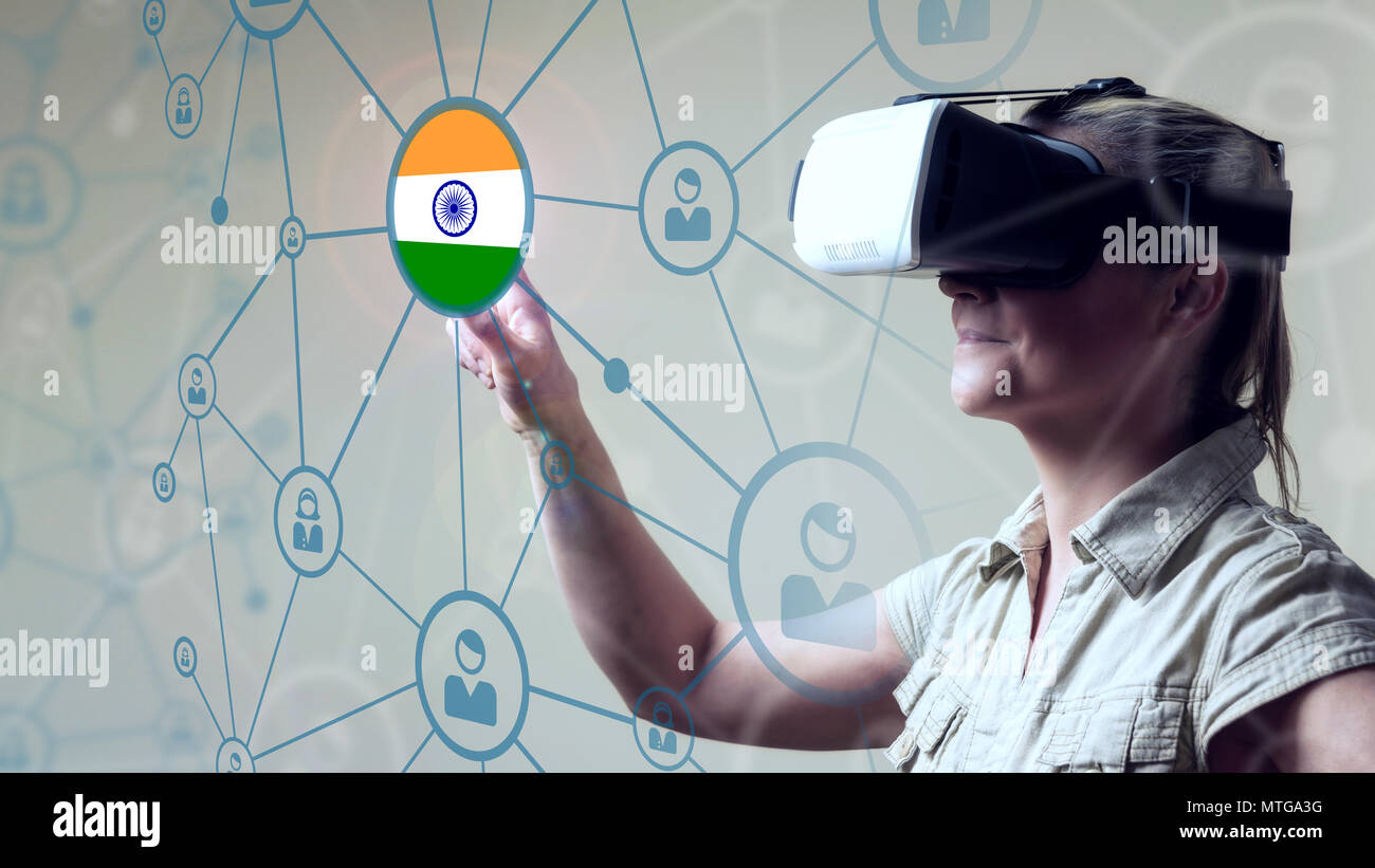 Young Woman looking through VR (Virtual Reality) glasses - Pointing Finger on screen British Flag Stock Photo