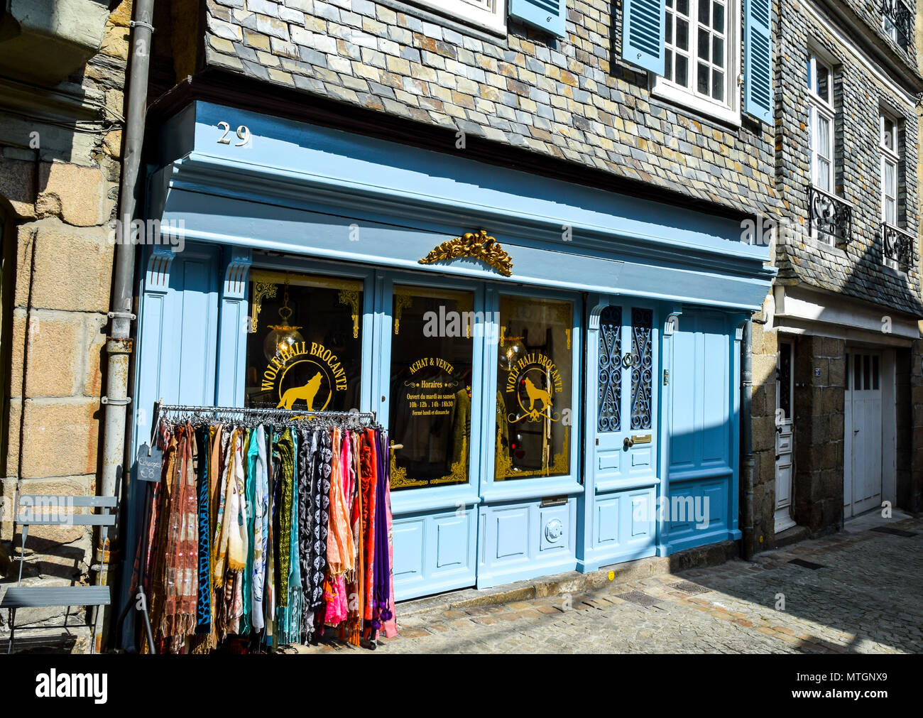 Blue-painted front facade of a small brocante in a narrow street in Morlaix, Brittany, France. Stock Photo