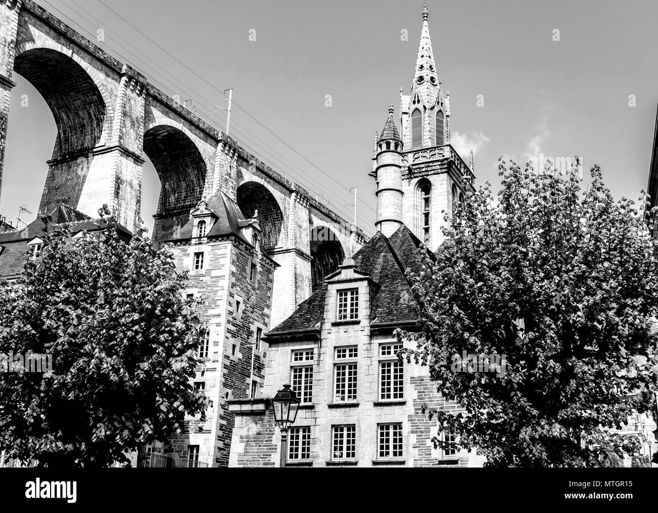 The 1800s viaduct in Morlaix, Brittany, France looms over the town below. Black & white. Stock Photo