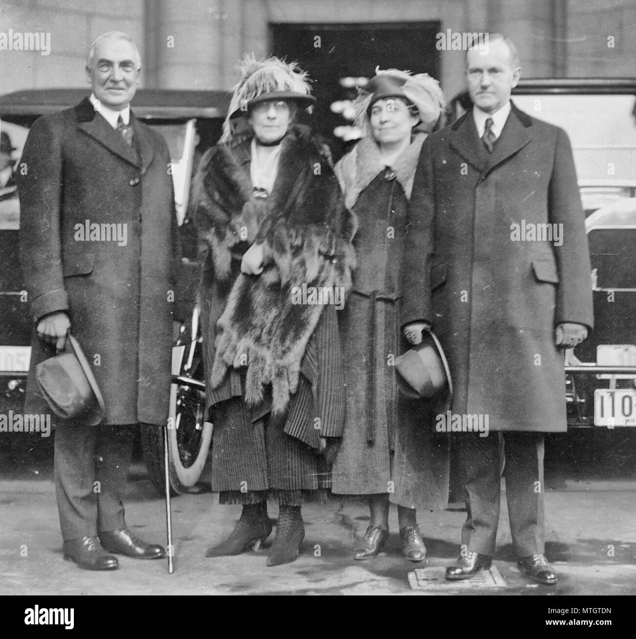 President and Mrs. Harding and Vice President and Mrs. Coolidge standing at Union Station, on their arrival for the inauguration. 1921 Stock Photo