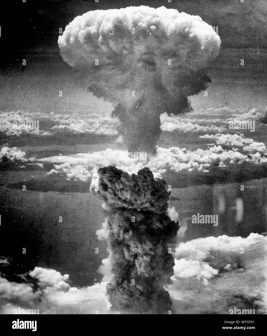 Atomic Cloud Rises Over Nagasaki, Japan - Mushroom cloud above Nagasaki after atomic bombing on August 9, 1945. Taken from the north west. Stock Photo