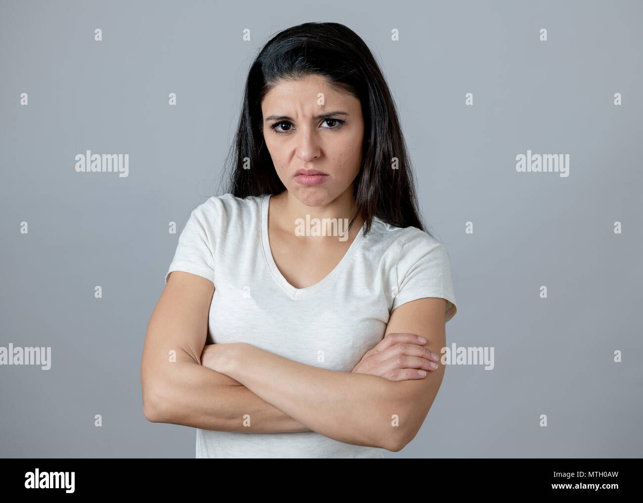 Close up portrait of an attractive young latin woman with an angry face.  looking furious and moody with an intense look showing anger and rage.  Human Stock Photo - Alamy