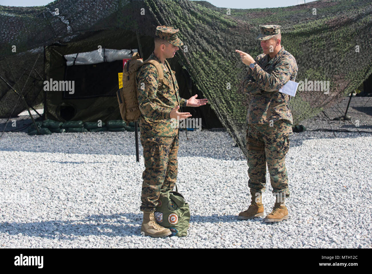 United States Marine (Left) Lt. Col. Giuseppe Stavale, III Marine Headquarters Group executive officer (III MHG) , (Right) Col. Brian M. Howlett, the Camp Commander at Camp Hansen having a discussion during Marine Expeditionary Force Exercise 2017(MEFEX 17) at Range GP 304 on Marine Corps Base Camp Hansen, Okinawa, Japan, April 24, 2017. MEFEX 17, a command and control exercise conducted in a simulated deployed environment, is designed to synchronize and bring to bear the full spectrum of III MEF, while remaining ready to provide the Marine Corps with an experienced staff capable of integratin Stock Photo