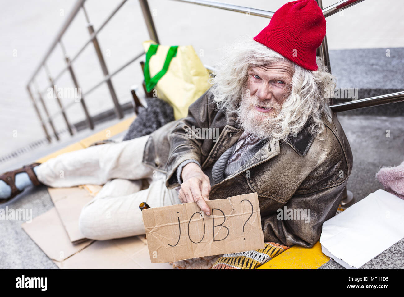 Homeless aged man searching for a job Stock Photo