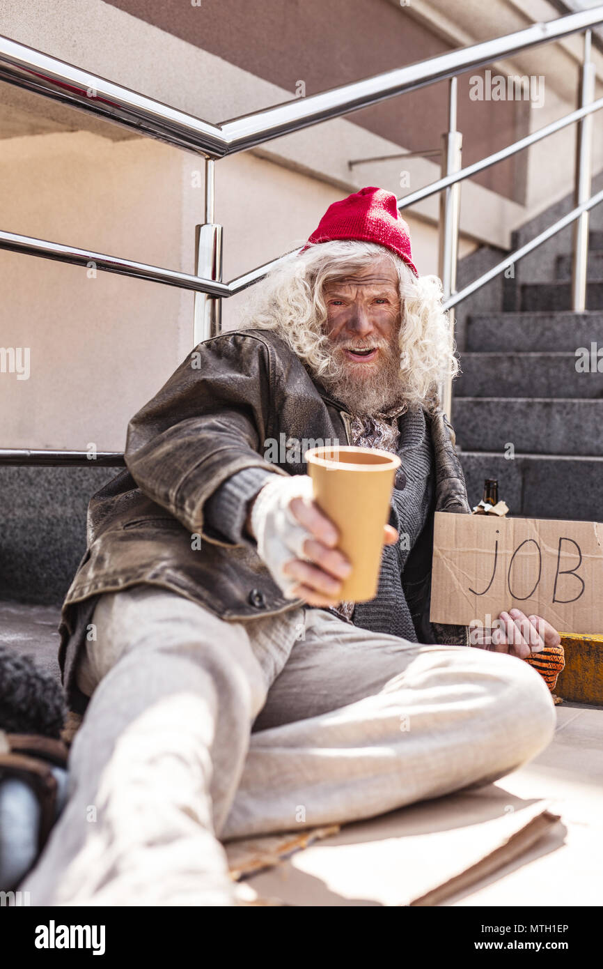 Cheerless homeless man asking for help Stock Photo - Alamy