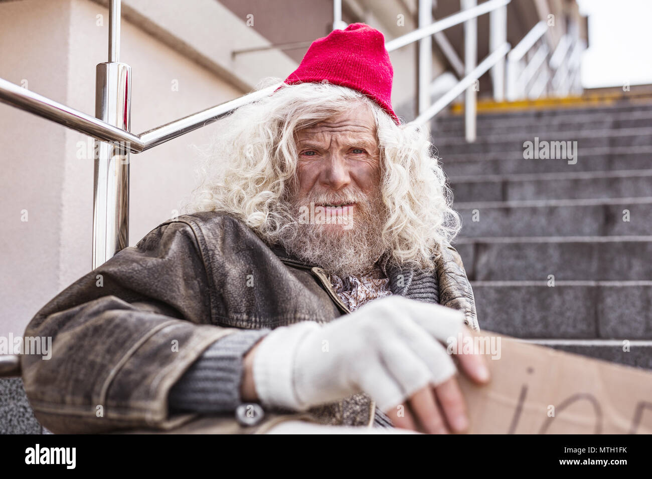 Cheerless poor man looking at you Stock Photo