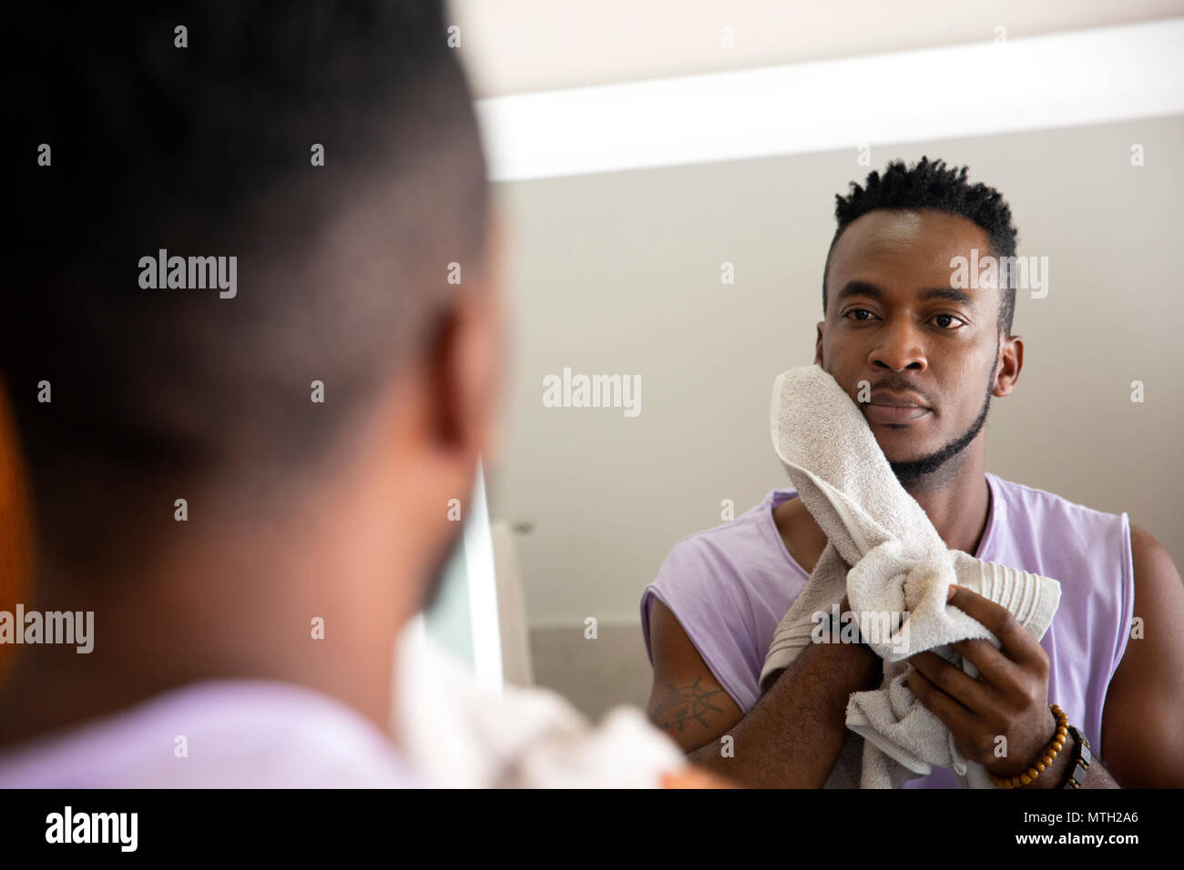 Man cleaning face with towel Stock Photo