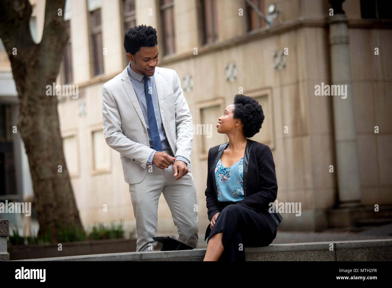 Business man and woman greeting each other Stock Photo