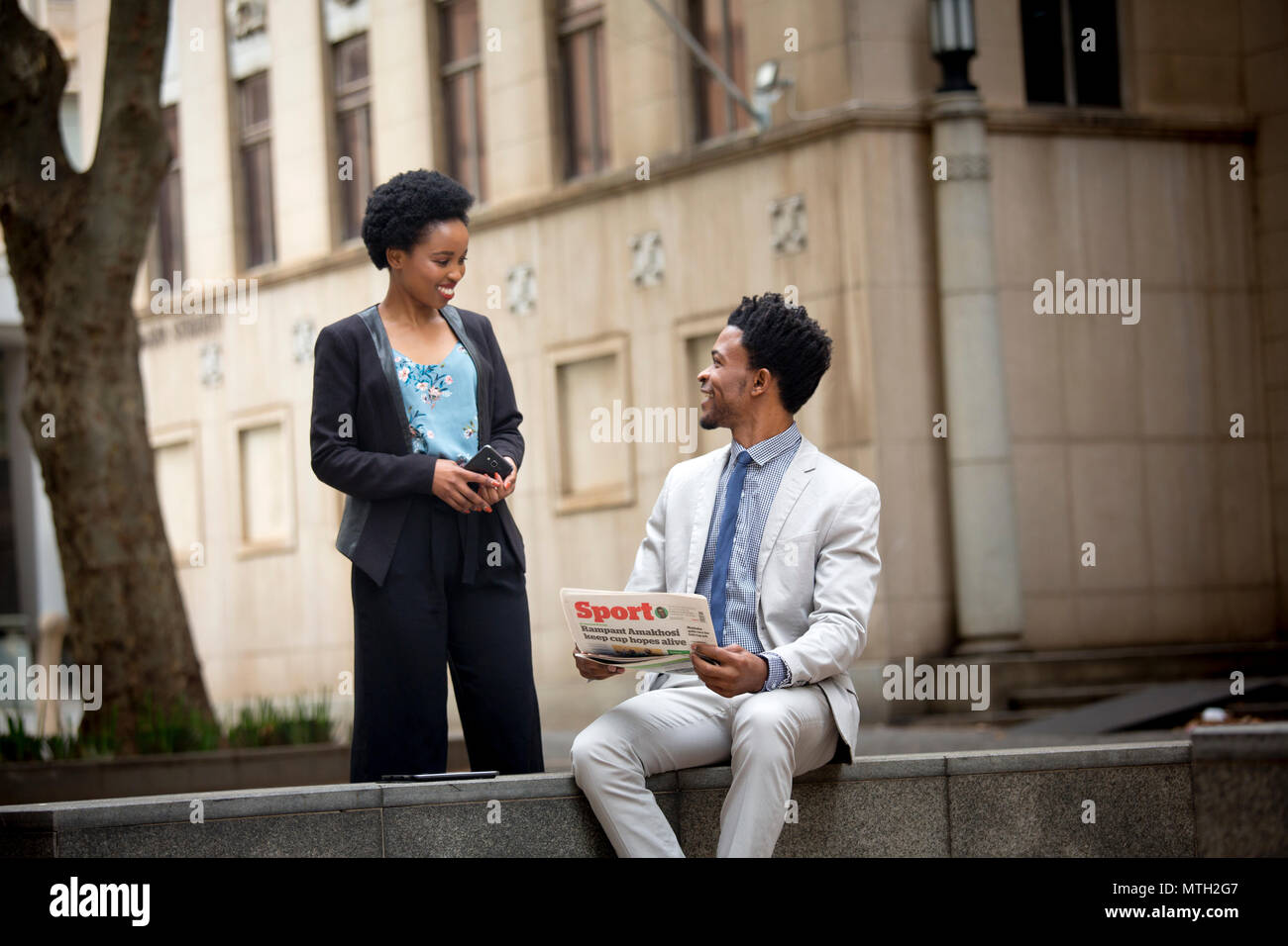 Business man and woman greeting each other Stock Photo