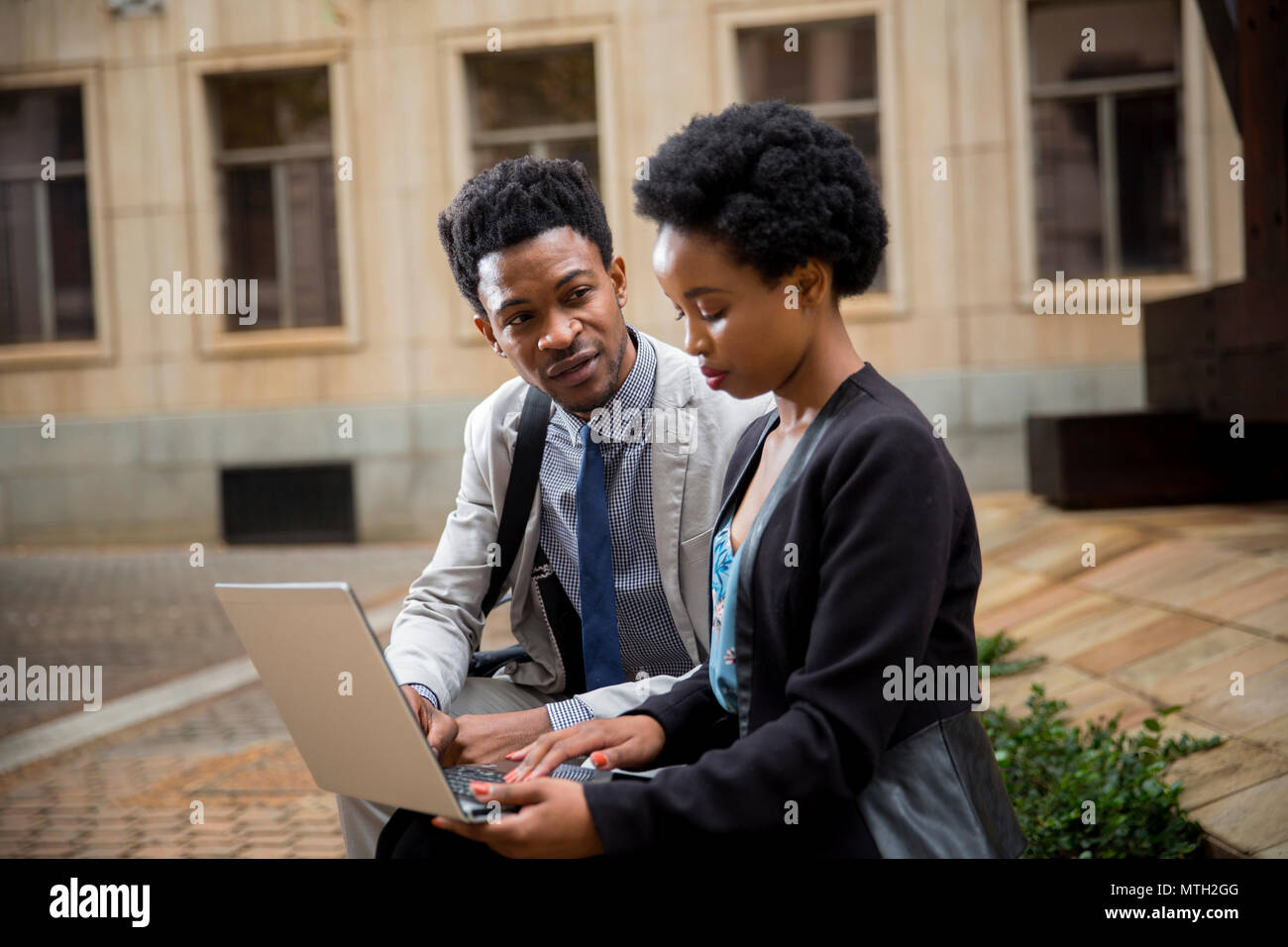 Business woman and man working on laptop Stock Photo