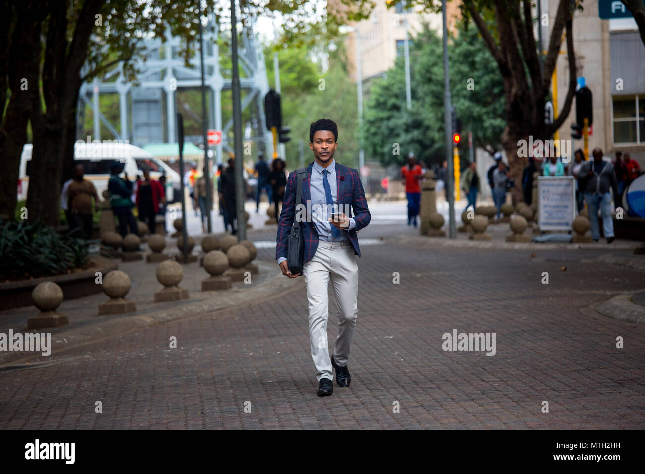 Business man walking through city Stock Photo