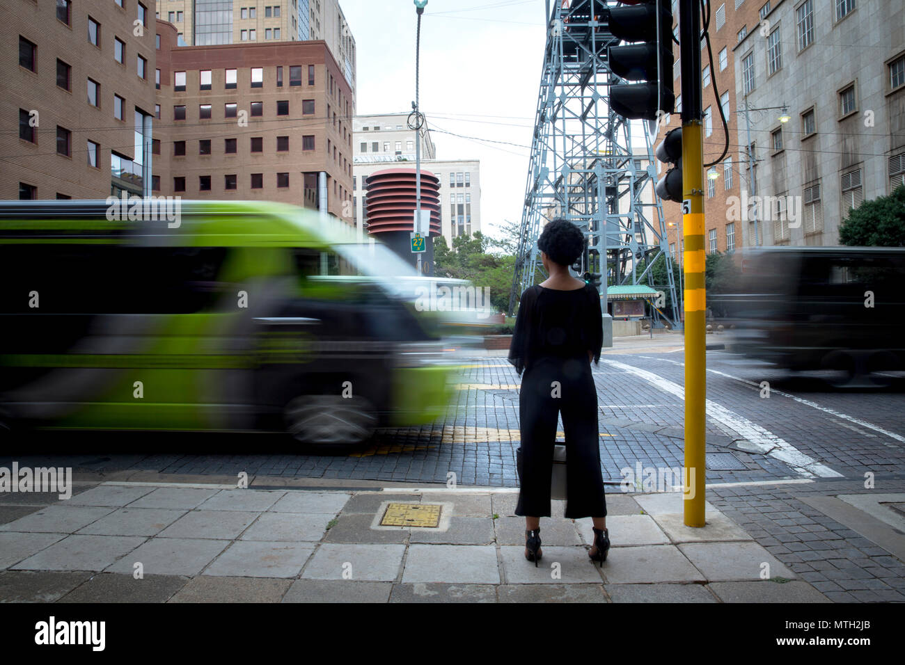 Woman waiting at traffic light Stock Photo