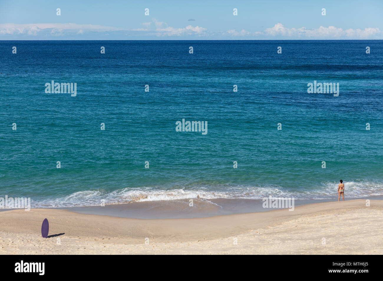 Surfboard and swimmer at Bronte Beach in Sydney, NSW, Australia Stock Photo