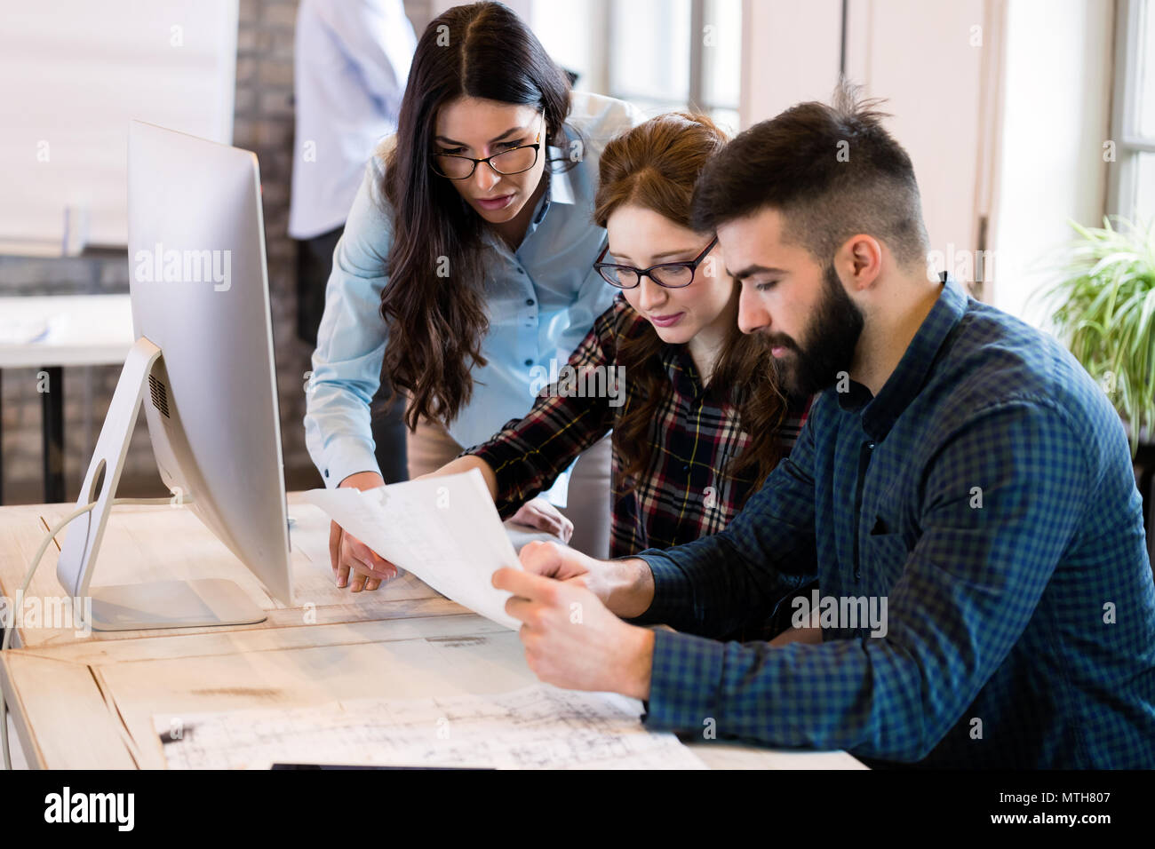 Young architects working on project in office Stock Photo