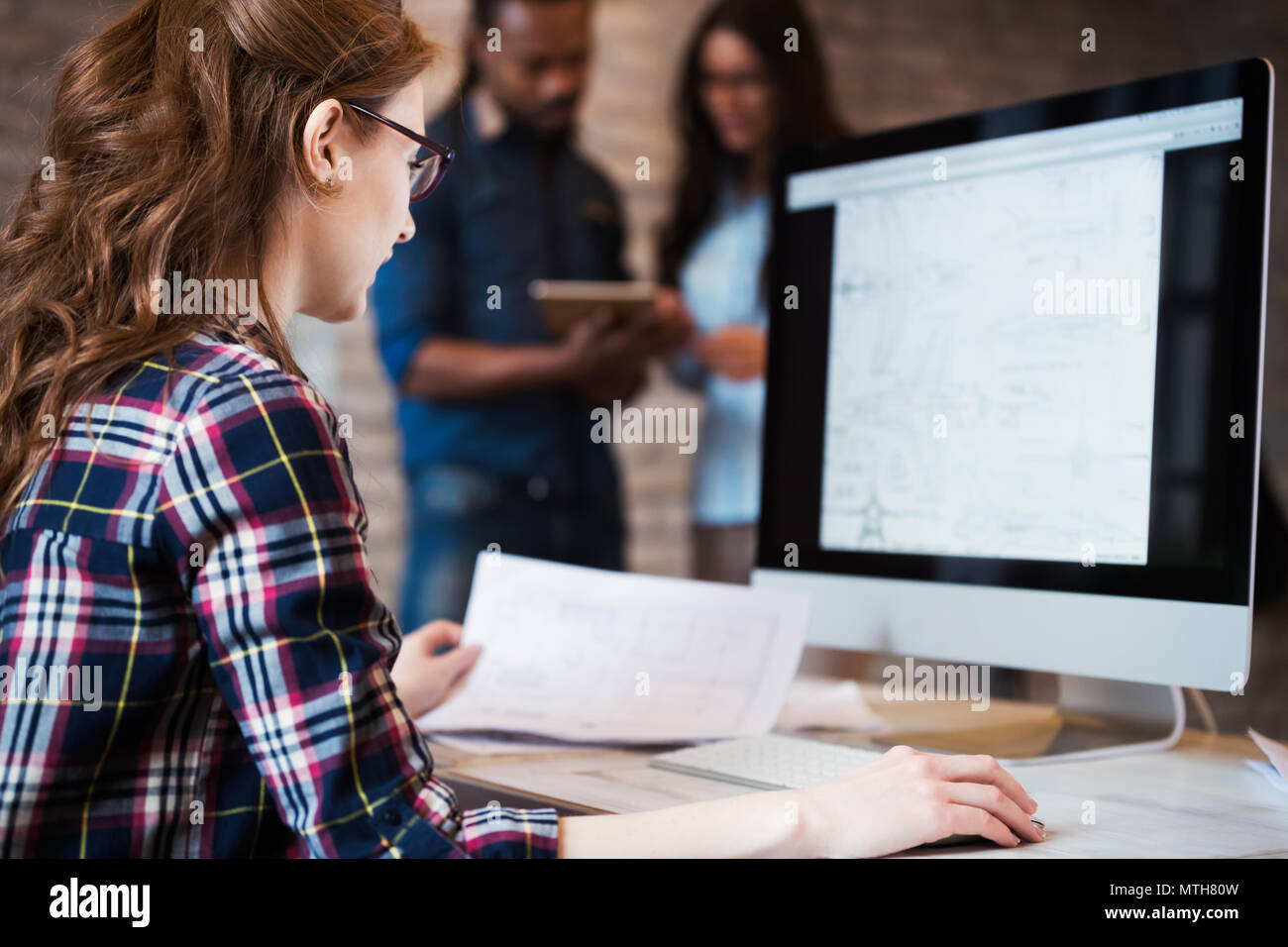 Young architect working on computer in office Stock Photo