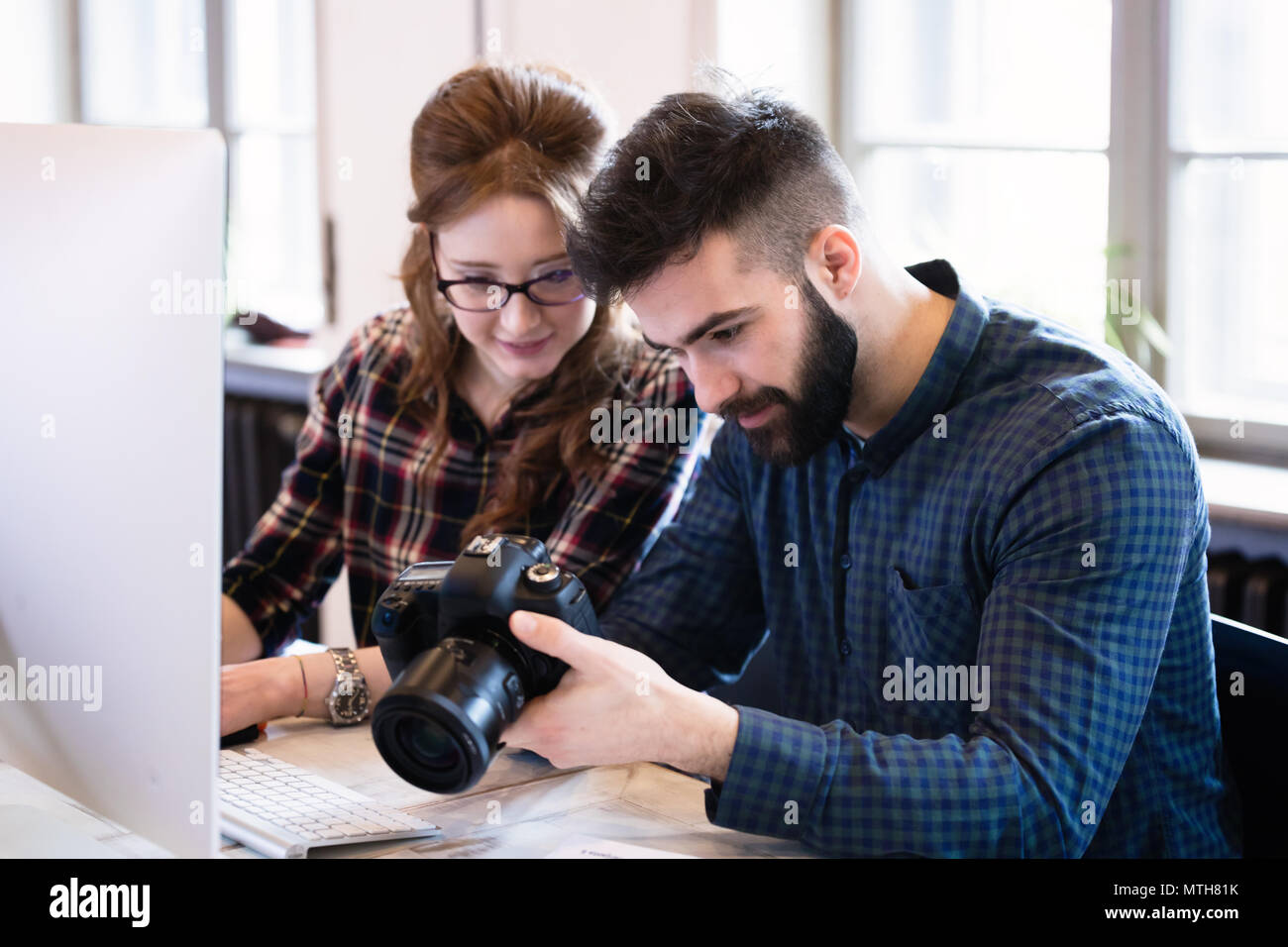Two young designers working in modern office Stock Photo