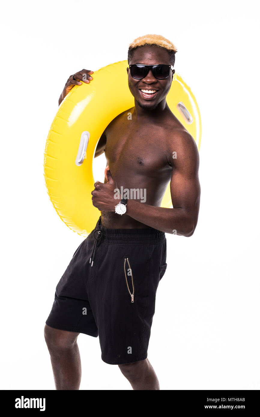 Portrait of a happy cheerful afro american man in summer shorts holding  inflatable ring and pointing finger at camera Stock Photo - Alamy