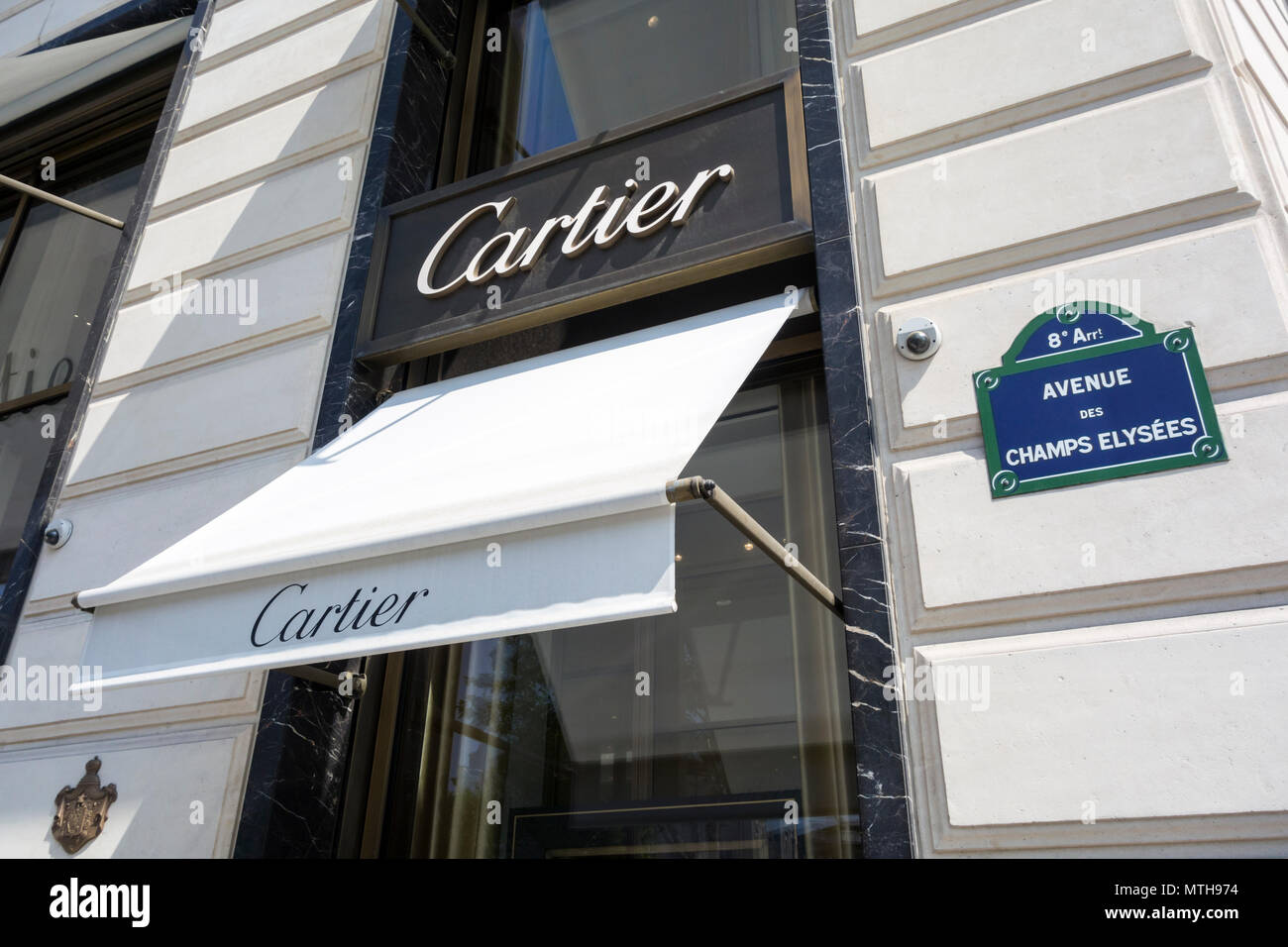 Cartier store at the Champs Elysées in Paris, France. With theChamps Elysées Street sign Stock Photo