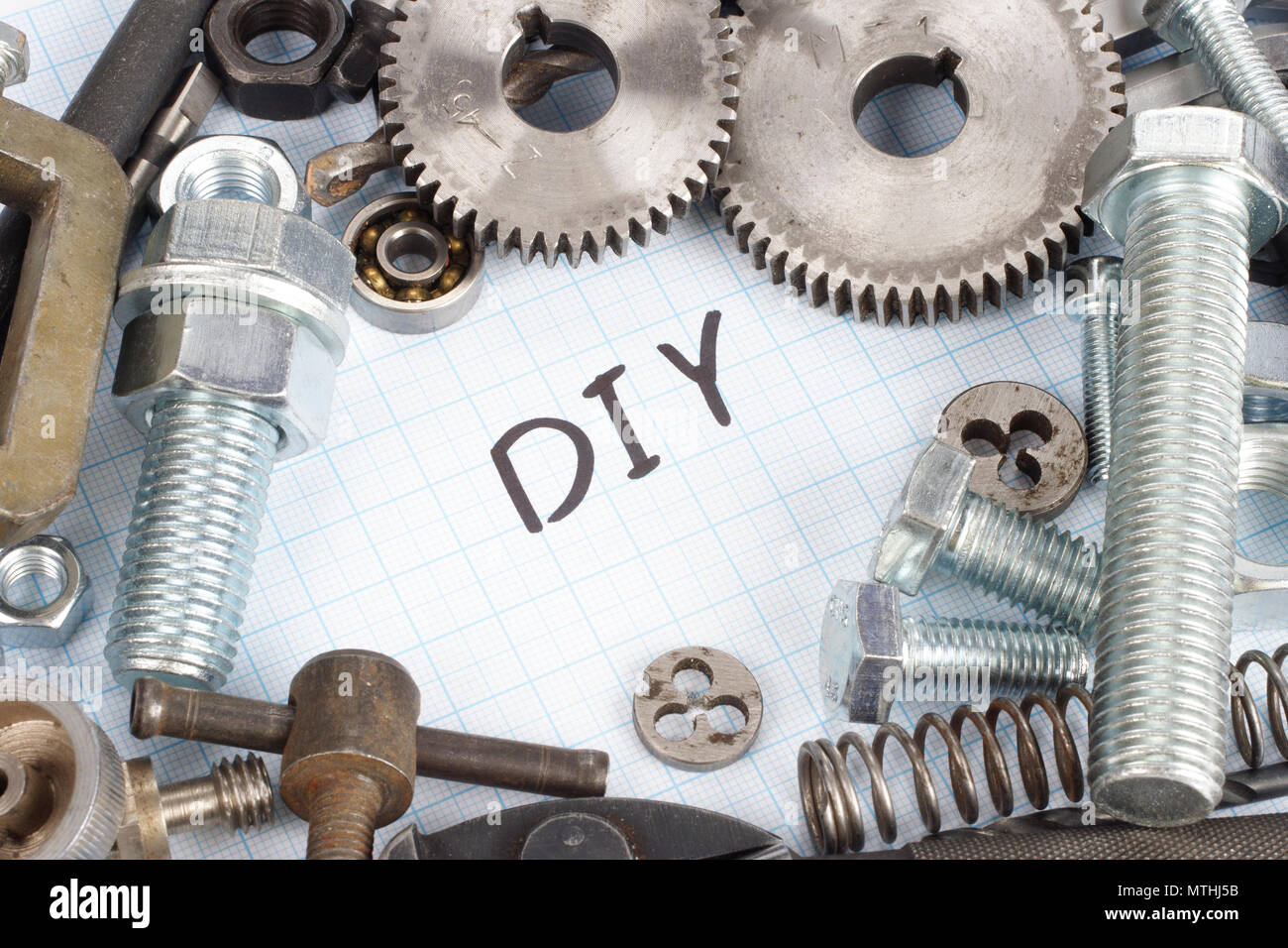 "Do it yourself" repair parts on graph paper background Stock Photo