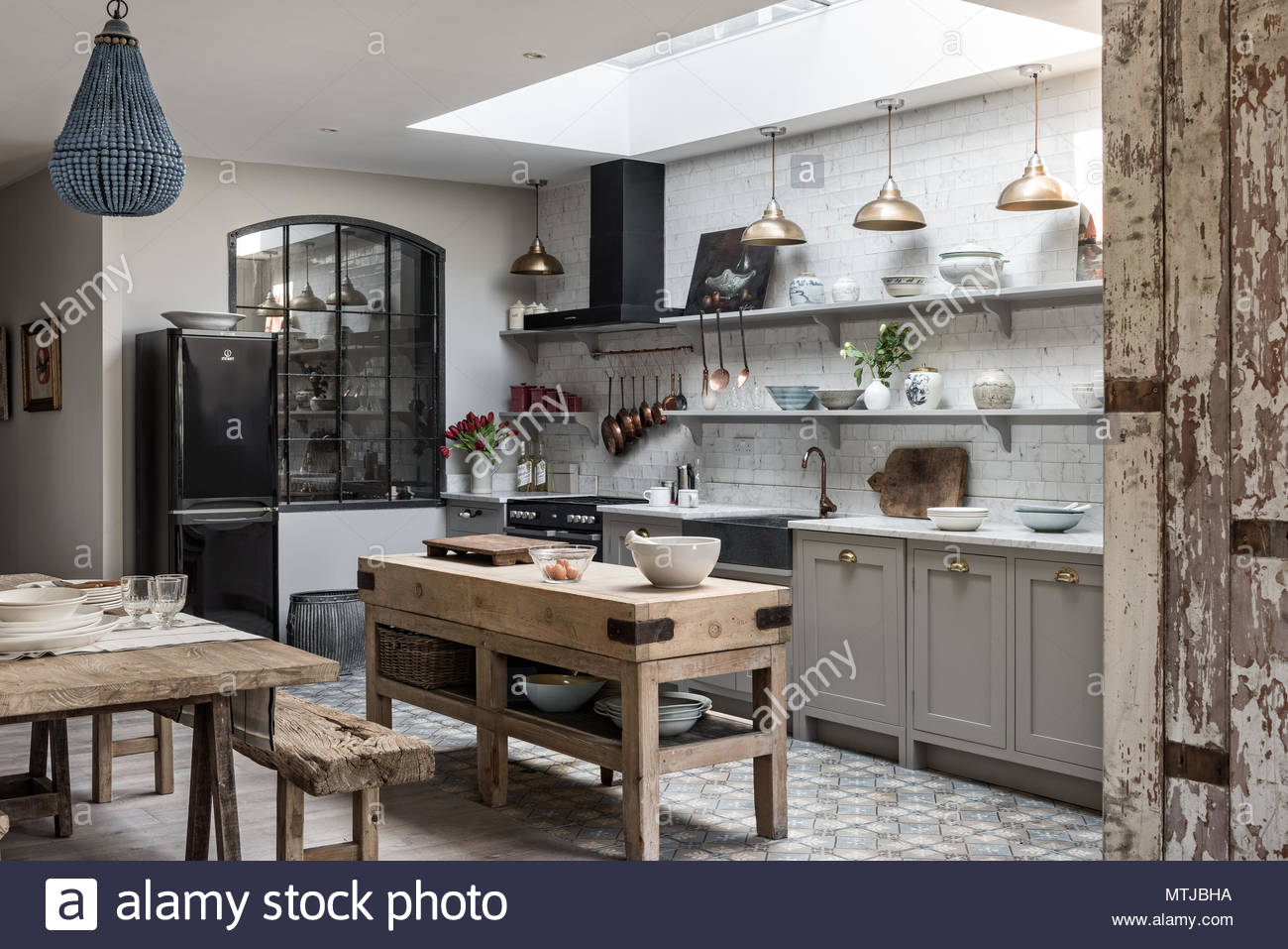 Open Plan Sophisticaed Kitchen With Vintage Brass Pendant Lighting Open Plan Sophisticaed Kitchen With Vintage Brass Pendant Lighting Rustic Wooden Butchers Island And Beaded Chandelier From Graham Green