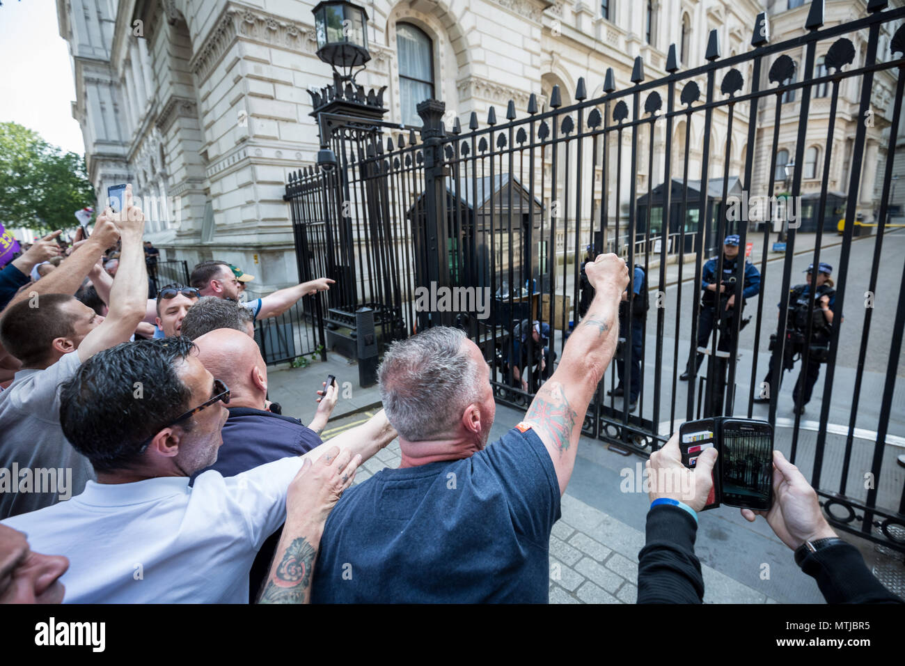 Nationalist supporters of Tommy Robinson protest opposite Downing Street in London against his recent imprisonment for contempt of court. Stock Photo