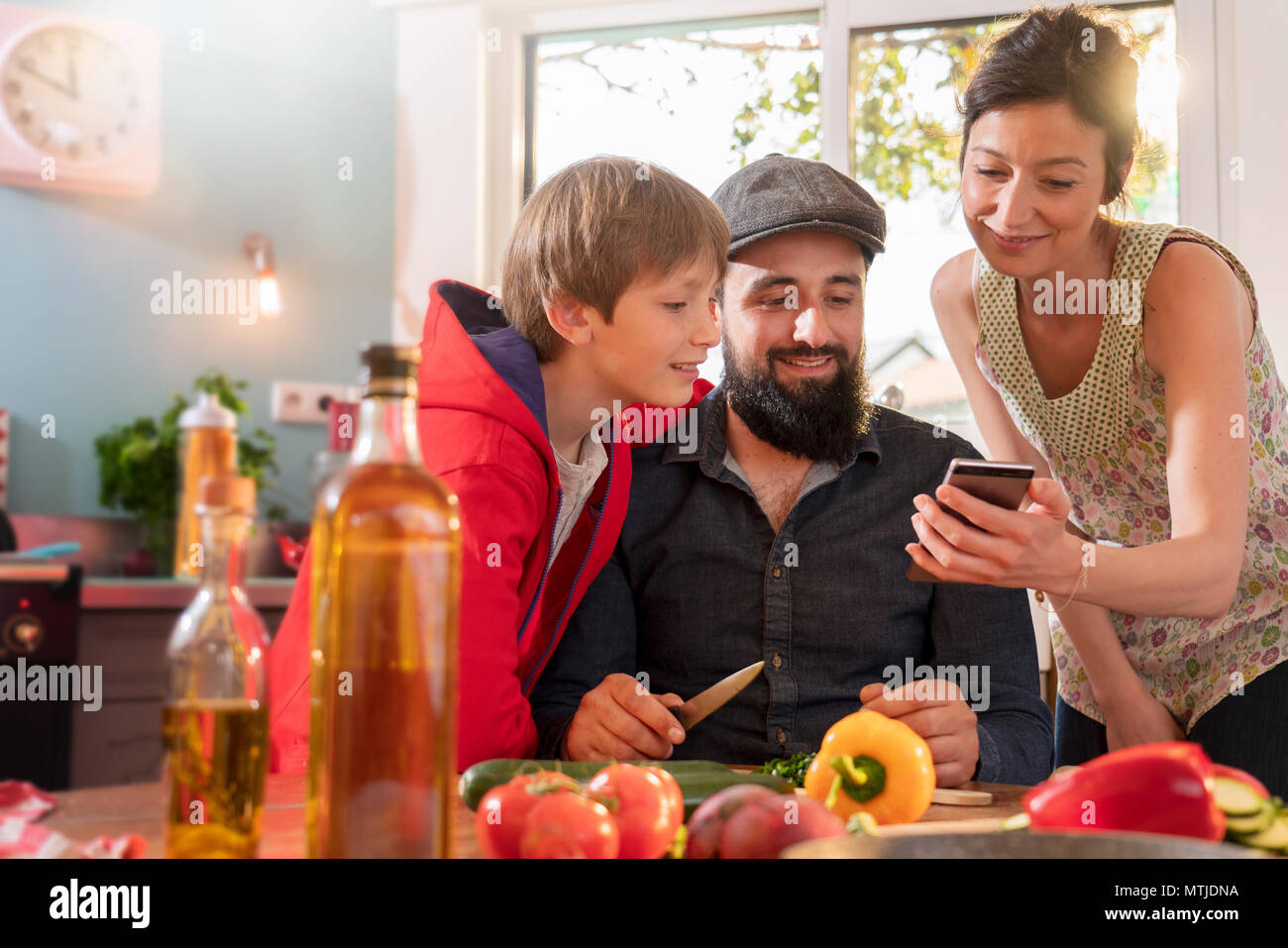 family having fun while preparing lunch in the kitchen. Stock Photo