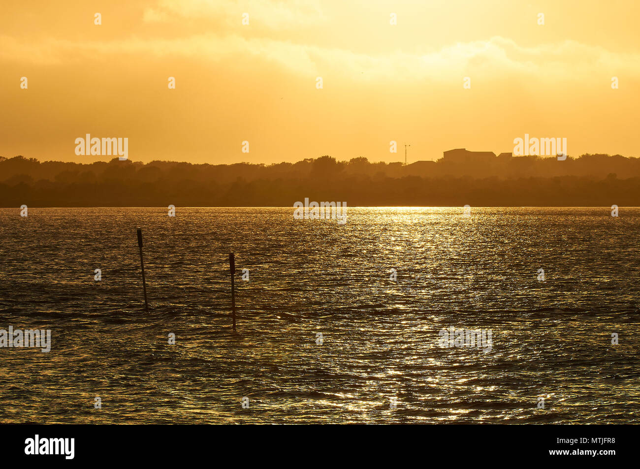 Golden sunset from Sa Boca with Can Marroig property backlighted in the background in Ses Salines Natural Park (Formentera, Balearic Islands, Spain) Stock Photo