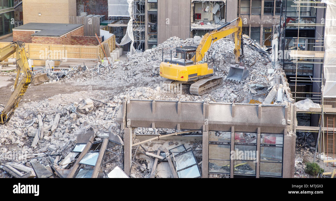 building site with heavy machinery knocking down a building to make way for something new Stock Photo