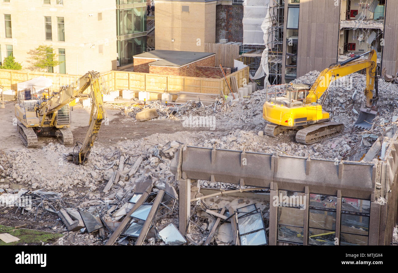 building site with heavy machinery knocking down a building to make way for something new Stock Photo