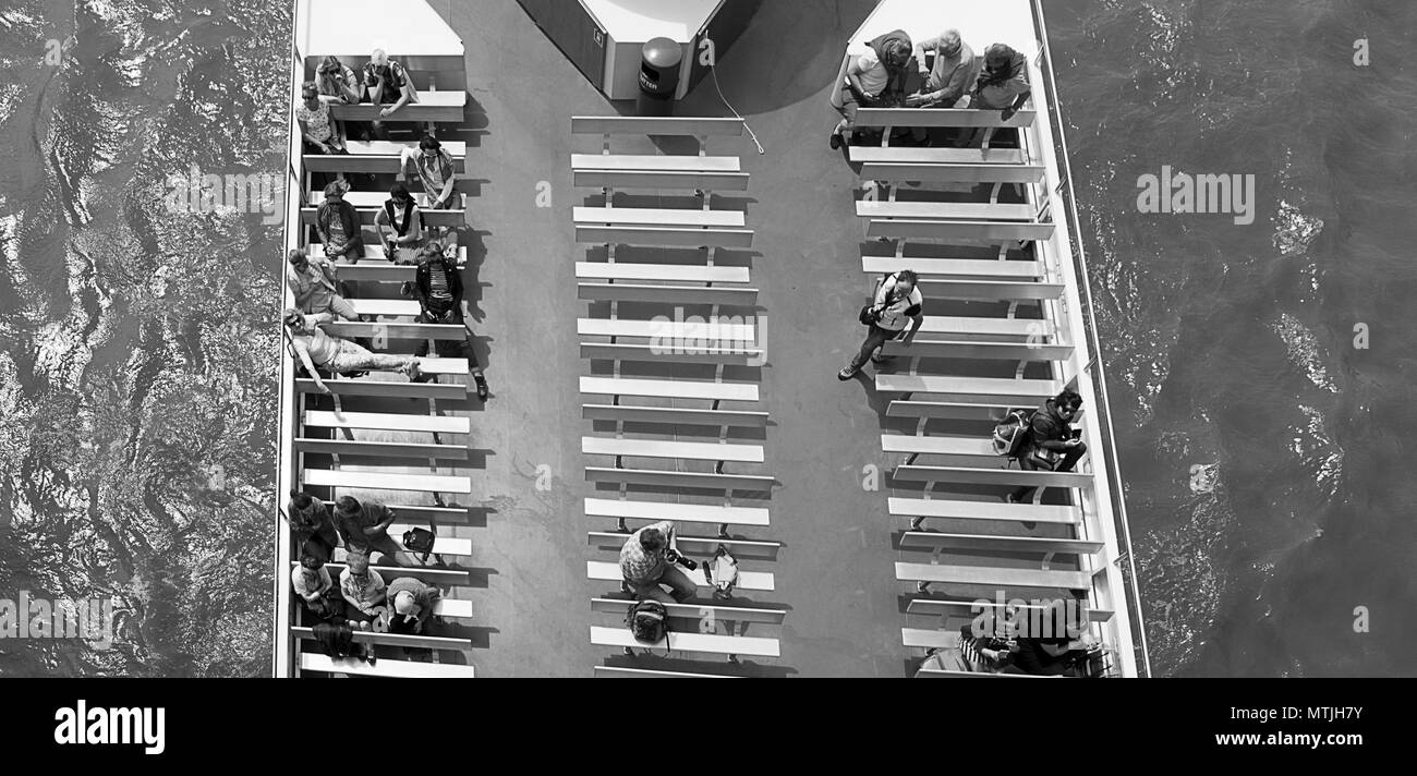 Passengers on a boat seen from above Stock Photo