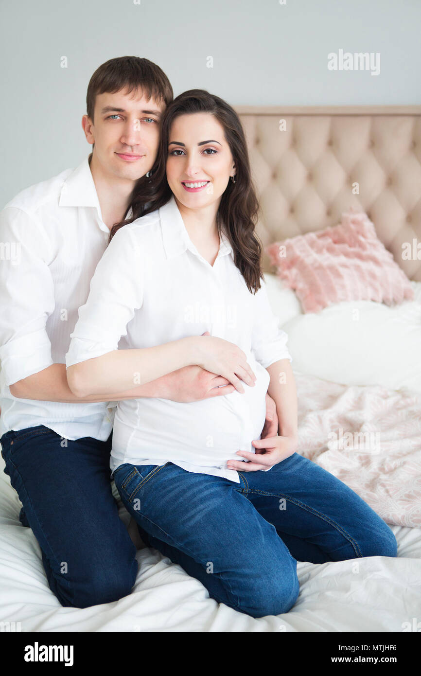 Portrait of the pregnant woman and young man together indoors Stock ...