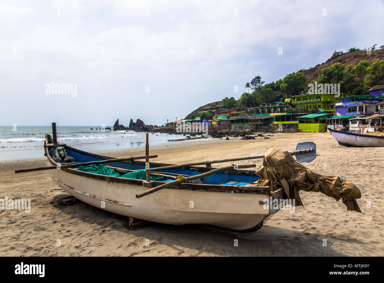 old fishing boat on tropical rocky beach Stock Photo