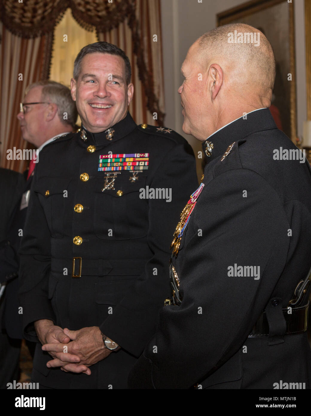 Commandant of the Marine Corps Gen. Robert B. Neller, right, speaks with Maj. Gen. John R. Ewers, Jr., staff judge advocate to the Commandant, before the 2017 Surprise Serenade at the Home of the Commandants, Washington, D.C., Jan. 1, 2017. The Surprise Serenade is a tradition that dates back to the mid-1800’s in which the U.S. Marine Band performs music for the Commandant of the Marine Corps at his home on New Years Day. (U.S. Marine Corps photo by Cpl. Samantha K. Braun) Stock Photo