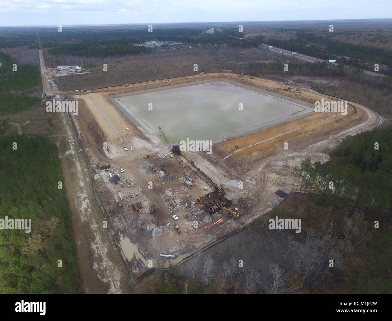 The picture displays construction progress on the Raw Water Storage Impoundment, as part of the Savannah Harbor Expansion Project, which currently sits at 53 percent completion. Progress shows the impoundment berm is up to 32 inches, out of its 42 inch final elevation. It features four pump cans (pictured bottom center inside cofferdam) connected to an effluent line and a raw water intake box set to an elevation of 36 inches (black structure at Southwest corner of impoundment). Construction on the reservoir began March 2016. It will provide an additional resource of fresh water that may be nee Stock Photo