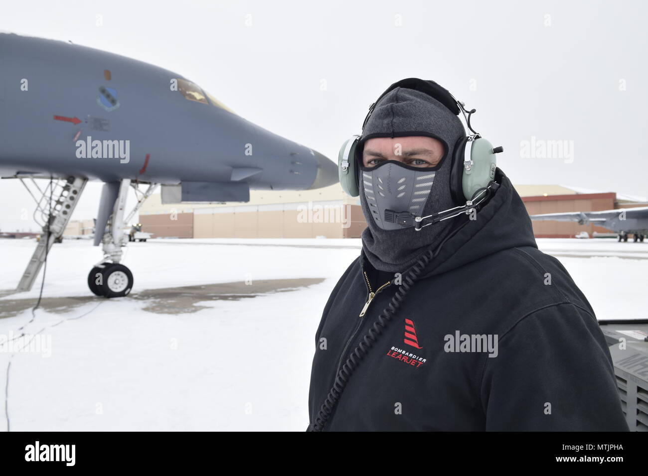 John Bishop, A B-1B mechanic with the 567th Aircraft Maintenance Squadron, wears a neoprene face mask during a B-1B Lancer engine run after the first significant snowfall Oklahoma City has received this season Jan. 6, 2017, Tinker Air Force Base, Oklahoma. Despite the accumulation of snow the important maintenance and sustainment operations conducted by the OC-ALC continued to ensure aircraft production stays on track to deliver capability to the warfighter.(U.S. Air Force photo/Greg L. Davis) Stock Photo