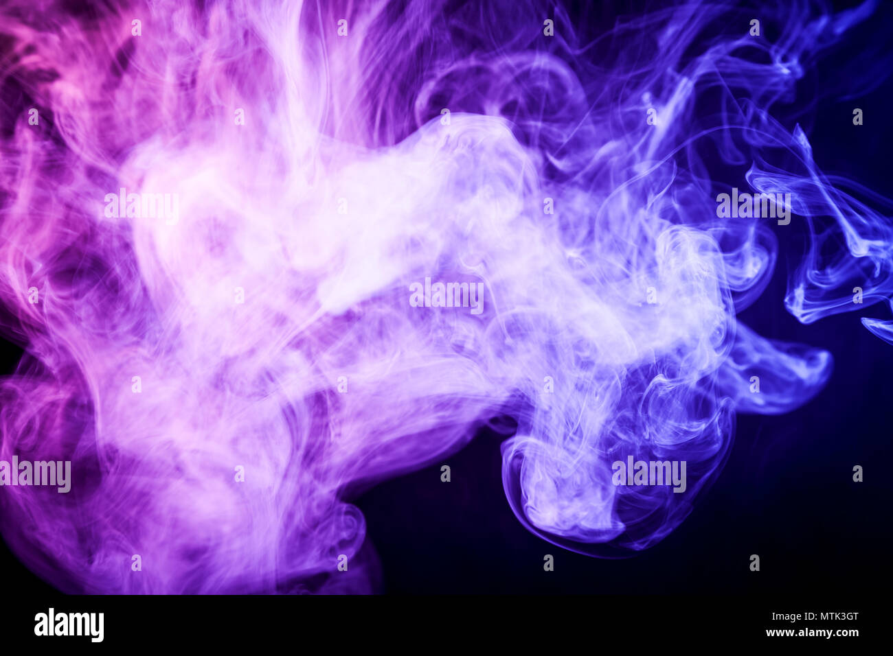 Cloud of purple smoke on a black isolated background. Background from the  smoke of vape Stock Photo - Alamy