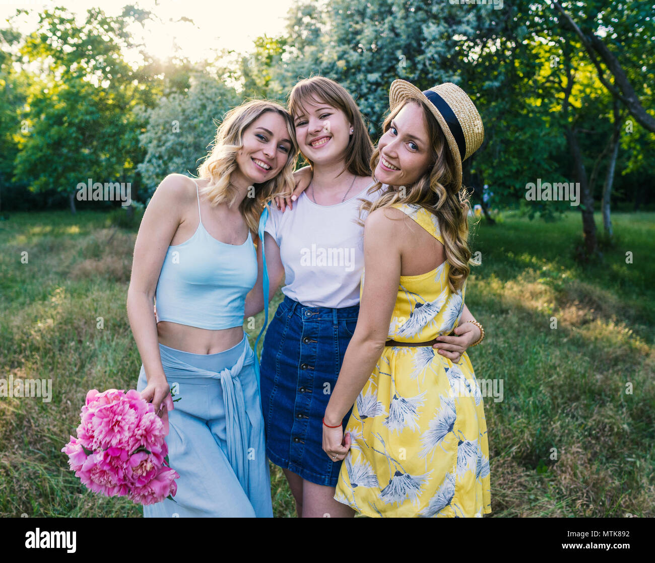 Group of girls friends with flowers having fun outdoors Stock Photo - Alamy