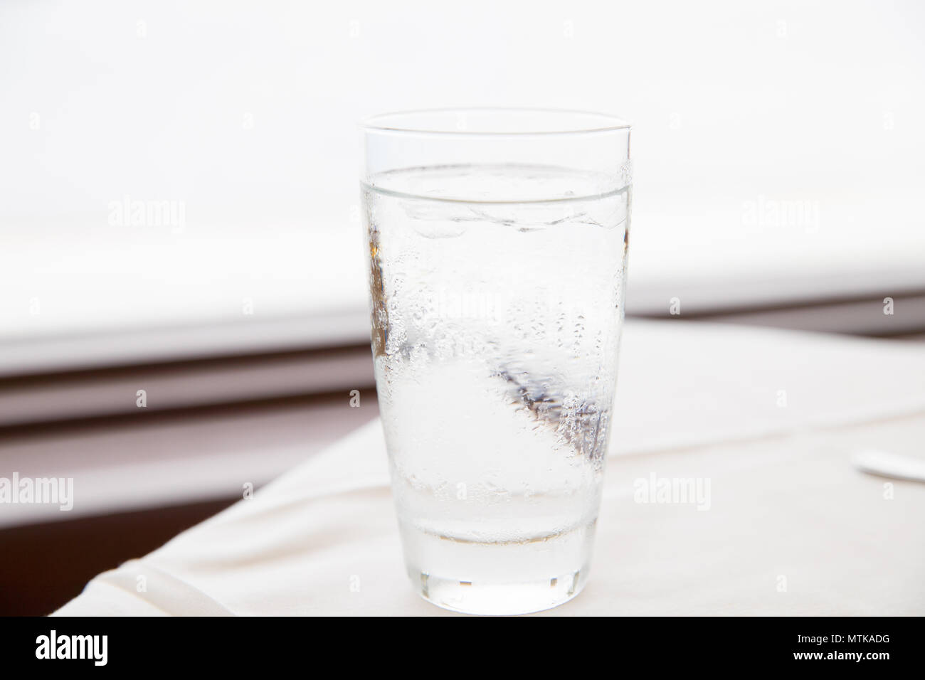 water glass with some ice Stock Photo - Alamy