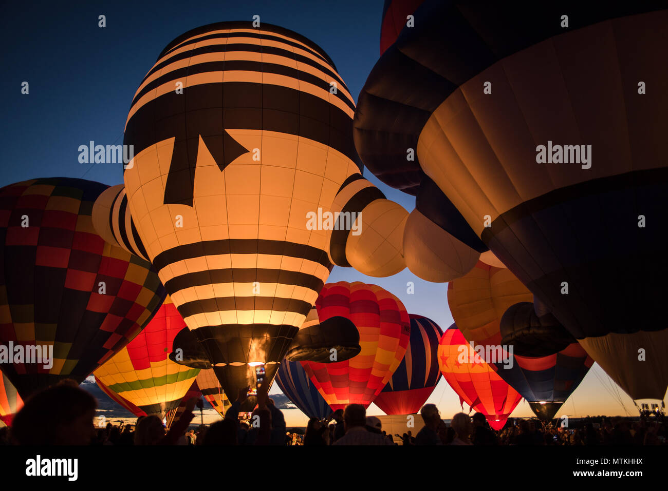 Colorful hot air balloons lit up in the night in Albuquerque, New Mexico. Stock Photo
