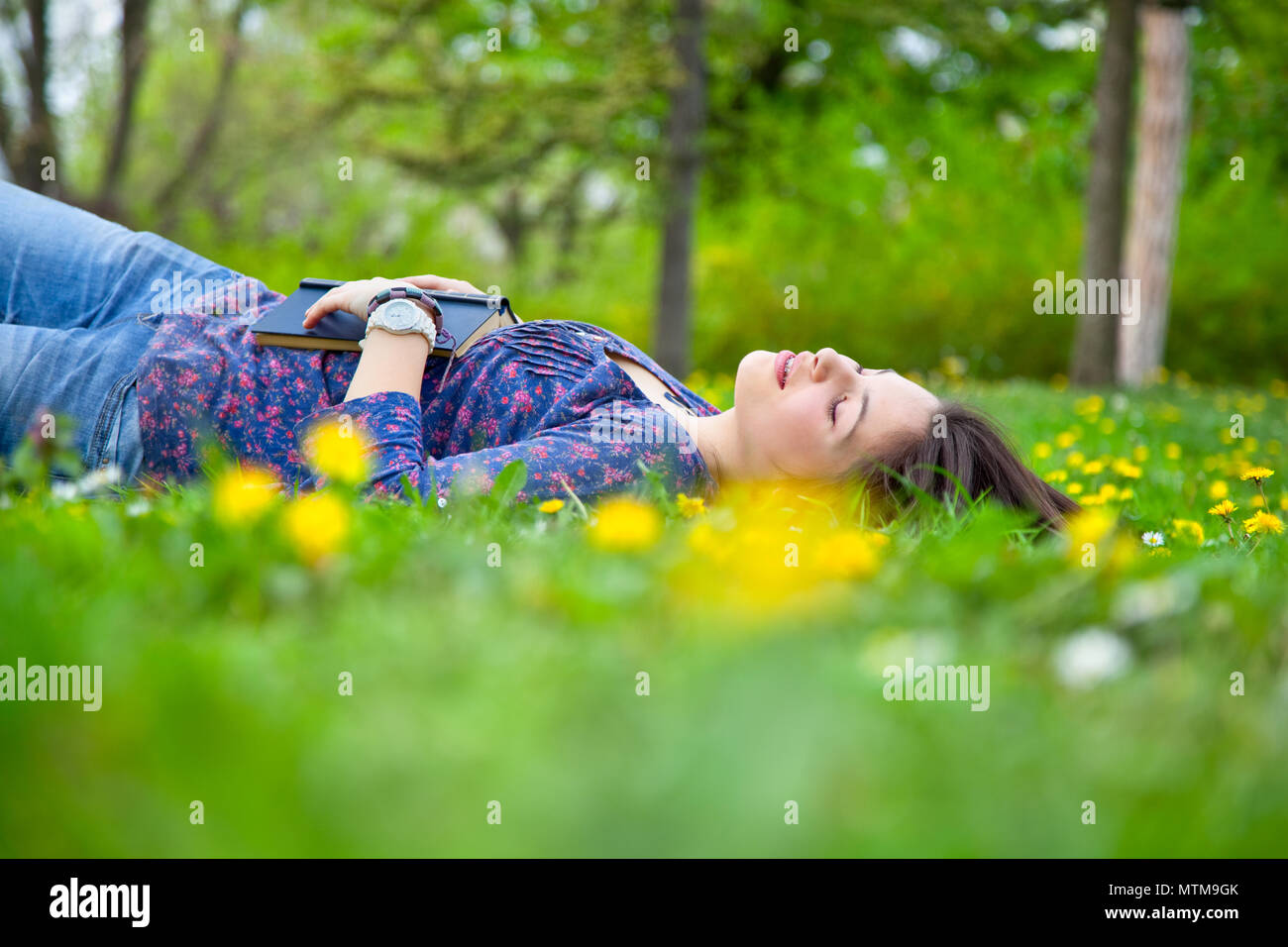 Portrait of cute young teenage girl relaxing in spring park Stock Photo ...