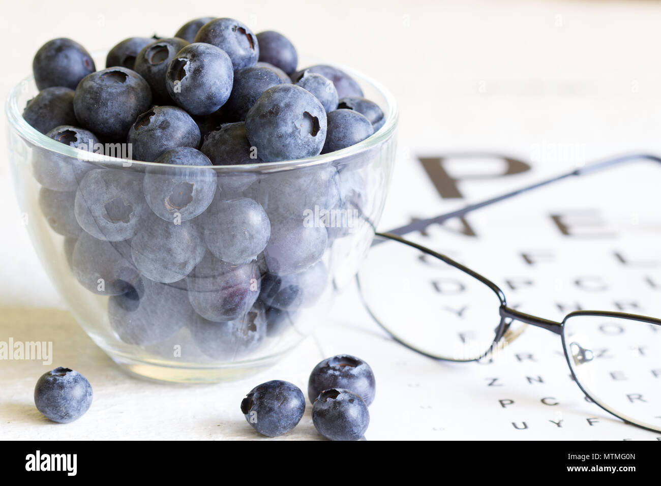 Bilberry cure for eyes concept with glasses Stock Photo Alamy