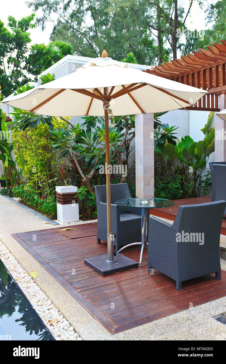 chairs and table at swimming pool Stock Photo Alamy