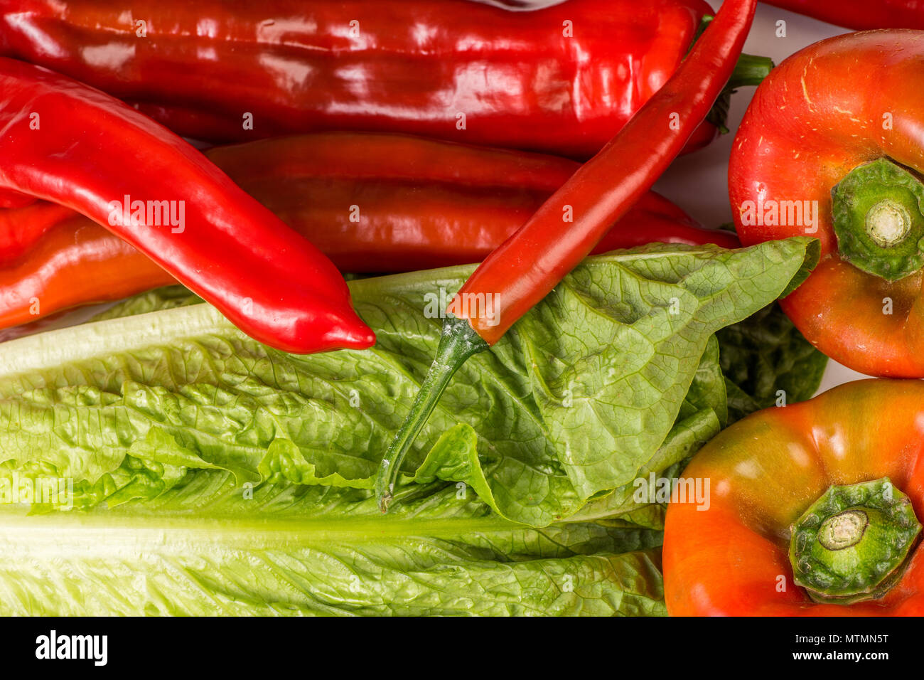 Organic Red Chili, Snack and Bell Pepper and Green Romaine lettuce, Close up and background Stock Photo
